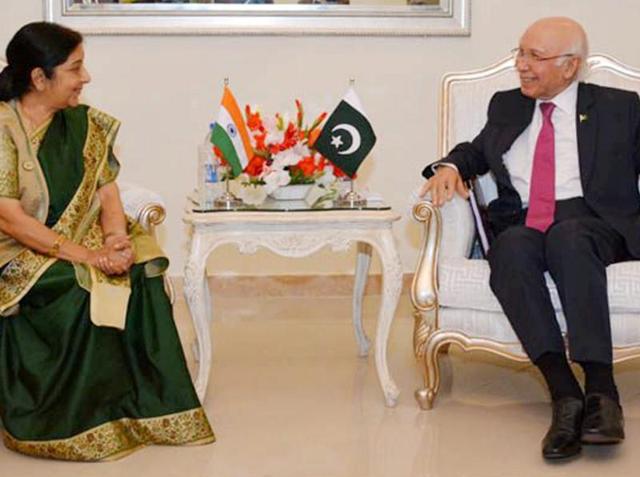 Indian Foreign Minister Sushma Swaraj shakes hand with Pakistani Prime Minister's adviser for Foreign Affairs Sartaj Aziz, right, prior to their meeting in Islamabad, Pakistan, Wednesday, Dec. 9, 2015. Swaraj told a news conference that India and Pakistan had agreed to resume talks, which have been on hold since August when Aziz suspended his visit to India over the issue of Kashmir.(AP)