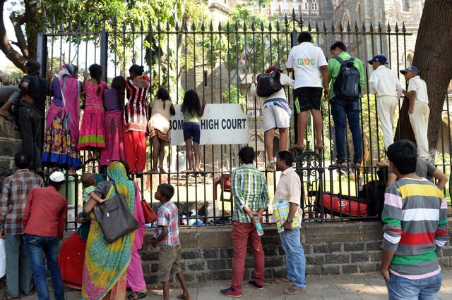 Bystanders cling onto the iron fencing of Bombay High Court in Mumbai as they attempt to catch a glimpse of Bollywood actor Salman Khan. (AFP Photo) Bystanders cling onto the iron fencing of Bombay High Court in Mumbai as they attempt to catch a glimpse of Bollywood actor Salman Khan. (AFP Photo)