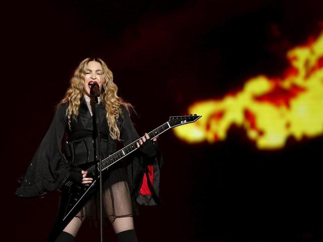 Singer Madonna channels the Doof Warrior from Mad Max during her concert at the AccorHotels Arena in Paris. (REUTERS) Singer Madonna channels the Doof Warrior from Mad Max during her concert at the AccorHotels Arena in Paris. (REUTERS)