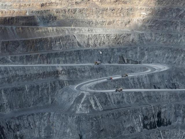Dump trucks loaded with gold-bearing soil drive from the bottom of a gold operation in Eastern Siberia, Russia. (REUTERS) Dump trucks loaded with gold-bearing soil drive from the bottom of a gold operation in Eastern Siberia, Russia. (REUTERS)