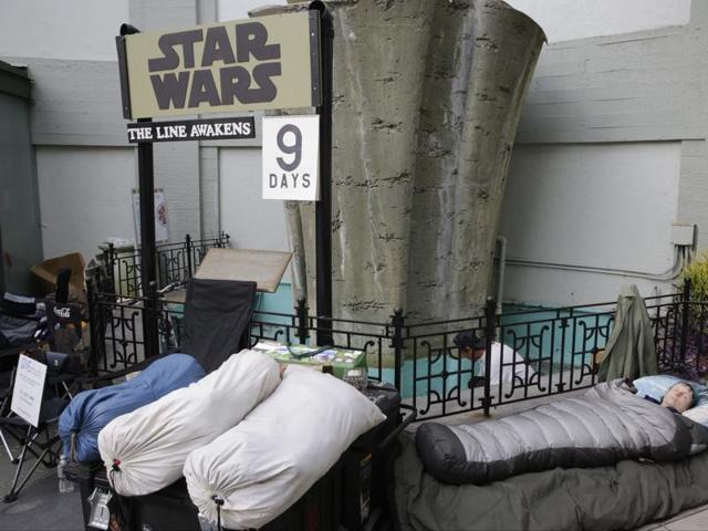 Star Wars fan Caroline Ritter of Hunter Valley, Australia, sleeps while waiting first in line for a chance to see the latest episode in the Star Wars Saga, Star Wars: The Force Awakens at the TCL Chinese Theater Imax in Los Angeles. Ritter is planning to get married at the historic theatre with a Star Wars themed wedding before the premiere of the film. (AP) 