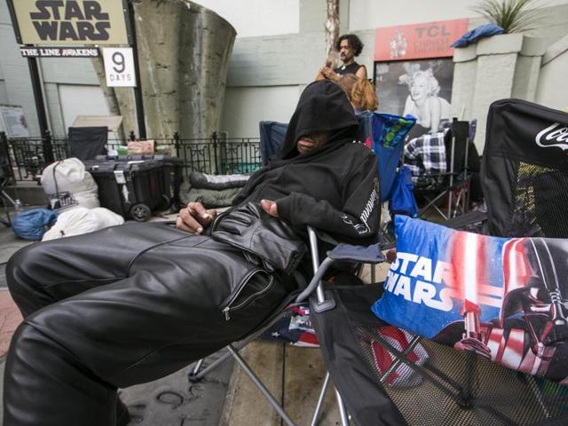 Star Wars fan, actor Deuce Wayne from Virginia rests outside the TCL Chinese Theater Imax while waiting for the premiere of Star Wars: The Force Awakens. (AP) 