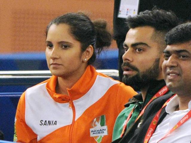 Indian cricket team captain Virat Kohli with Tennis player Sania Mirza watching the men's doubles match at International Premier Tennis League (IPTL) at IG stadium in New Delhi on Thursday. (PTI) Indian cricket team captain Virat Kohli with Tennis player Sania Mirza watching the men's doubles match at International Premier Tennis League (IPTL) at IG stadium in New Delhi on Thursday. (PTI)
