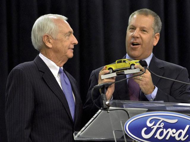 Joe Hinrichs, Ford Motor Company's President of the Americas, left, makes a presentation of a Ford Super Duty truck to Kentucky Governor Steve Beshear following his announcement that the Ford Motor Co. will be adding 2,000 jobs and investing $1.3 billion at the Kentucky Truck Plant in Louisville to build the new aluminum-body Super Duty truck. (AP)