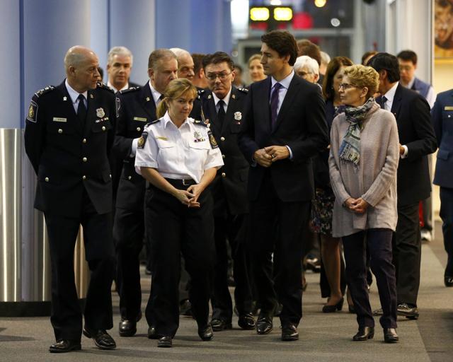 Canada's Prime Minister Justin Trudeau arrives with Ontario premier Kathleen Wynne to await Syrian refugees at the Toronto Pearson International Airport in Mississauga, Ontario. (Reuters )