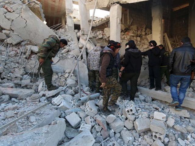 Kurdish fighters from the People's Protection Units (YPG) inspect damage at a site hit by one of the three truck bombs, in the YPG-controlled town of Tel Tamer, Syria. (Reuters Photo) Kurdish fighters from the People's Protection Units (YPG) inspect damage at a site hit by one of the three truck bombs, in the YPG-controlled town of Tel Tamer, Syria. (Reuters Photo)