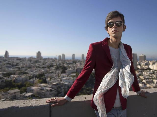 Iranian poet Payam Feili poses for a photograph in Tel Aviv, Israel. Feili, who bears a coin-sized Star of David tattoo on his neck, said his fascination with Israel was sparked as a youngster, when he began watching films about the Holocaust and started learning about the Torah. (AP Photo) Iranian poet Payam Feili poses for a photograph in Tel Aviv, Israel. Feili, who bears a coin-sized Star of David tattoo on his neck, said his fascination with Israel was sparked as a youngster, when he began watching films about the Holocaust and started learning about the Torah. (AP Photo)