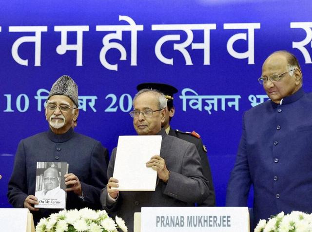 President Pranab Mukherjee with vice president Hamid Ansari and Prime Minister Narendra Modi releases a book on NCP chief Sharad Pawar (R) during his 75th birthday celebration at Vigyan Bhawan in New Delhi on Thursday.(PTI)