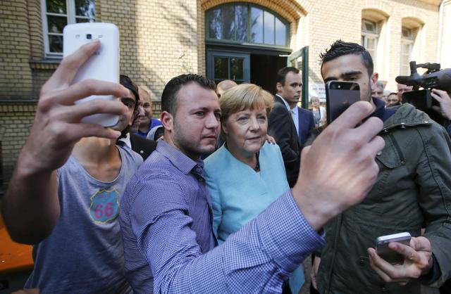 File photo of migrants from Syria and Iraq taking selfies with German Chancellor Angela Merkel outside a refugee camp in Berlin. (REUTERS) File photo of migrants from Syria and Iraq taking selfies with German Chancellor Angela Merkel outside a refugee camp in Berlin. (REUTERS)