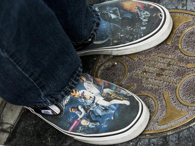 A Star Wars fan wearing Star Was-themed sneakers lines up outside the TCL Chinese Theater Imax for the Star Wars: The Force Awakens premiere. (AP) 