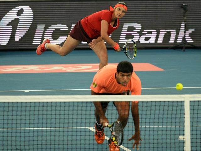 India's Sania Mirza of the Indian Aces serves past partner and compatriot Rohan Bopanna during the International Premier Tennis League (IPTL) tennis match between Indian Aces and Philippine Mavericks in New Delhi. (AFP) India's Sania Mirza of the Indian Aces serves past partner and compatriot Rohan Bopanna during the International Premier Tennis League (IPTL) tennis match between Indian Aces and Philippine Mavericks in New Delhi. (AFP)