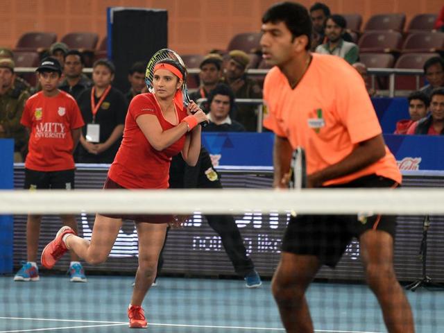 India's Sania Mirza of the Indian Aces plays a shot past partner and compatriot Rohan Bopanna during the International Premier Tennis League (IPTL) tennis match between Indian Aces and Philippine Mavericks in New Delhi. (AFP) India's Sania Mirza of the Indian Aces plays a shot past partner and compatriot Rohan Bopanna during the International Premier Tennis League (IPTL) tennis match between Indian Aces and Philippine Mavericks in New Delhi. (AFP)