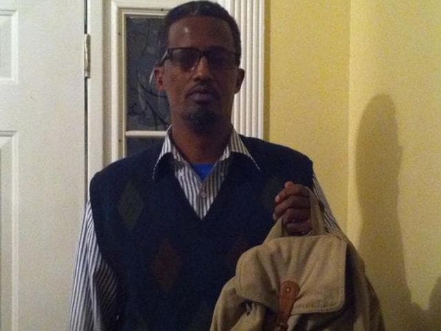 Abdirizak Aden holds his daughter’s bookbag. A teacher asked his 13-year-old daughter if it contained a bomb.