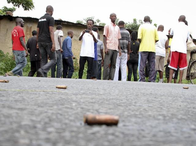 A man looks across at spent bullet casings lying on a street in the Nyakabiga neighborhood of Bujumbura, Burundi. (AP) A man looks across at spent bullet casings lying on a street in the Nyakabiga neighborhood of Bujumbura, Burundi. (AP)