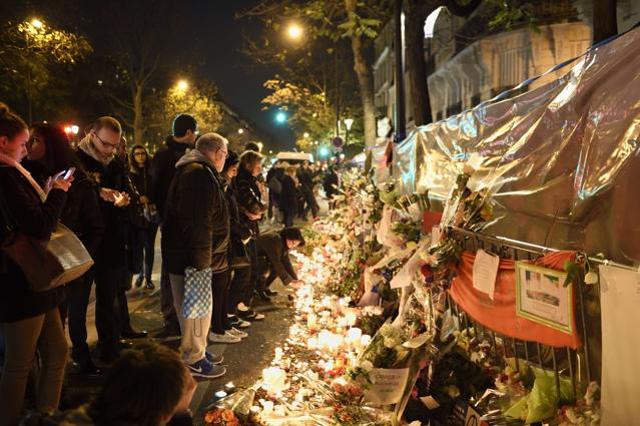 People gather at a makeshift memorial in tribute to the victims of a series of deadly attacks in Paris, in front of the Bataclan cafe on Voltaire Boulevard in Paris. (AFP Photo) People gather at a makeshift memorial in tribute to the victims of a series of deadly attacks in Paris, in front of the Bataclan cafe on Voltaire Boulevard in Paris. (AFP Photo)