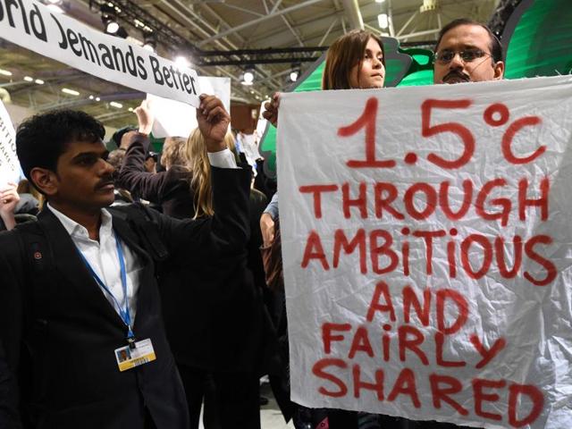 Members of a non-governmental organization (NGO)demonstrate during the COP 21 United Nations conference on climate change at Le Bourget, on the outskirts of Paris.(AFP)