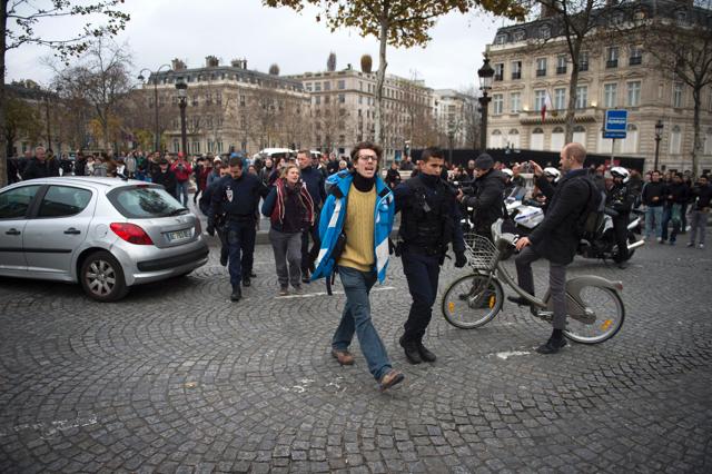 French Police officers arrest Greenpeace activists after they sprayed yellow paint on the Etoile square in front of the Arc de Triomphe in Paris. (AFP) French Police officers arrest Greenpeace activists after they sprayed yellow paint on the Etoile square in front of the Arc de Triomphe in Paris. (AFP)