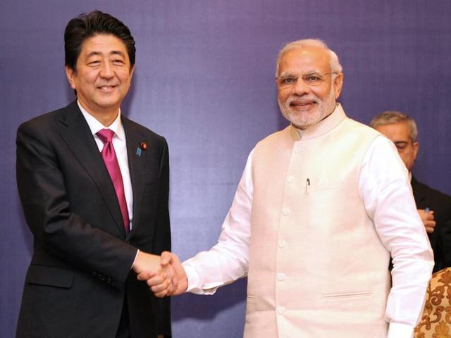In this handout photograph released by PIB, Prime Minister Narendra Modi (R) shakes hands with Japan’s Prime Minister Shinzo Abe ahead of a meeting at a business forum in New Delhi.(PIB Photo) In this handout photograph released by PIB, Prime Minister Narendra Modi (R) shakes hands with Japan’s Prime Minister Shinzo Abe ahead of a meeting at a business forum in New Delhi.(PIB Photo)