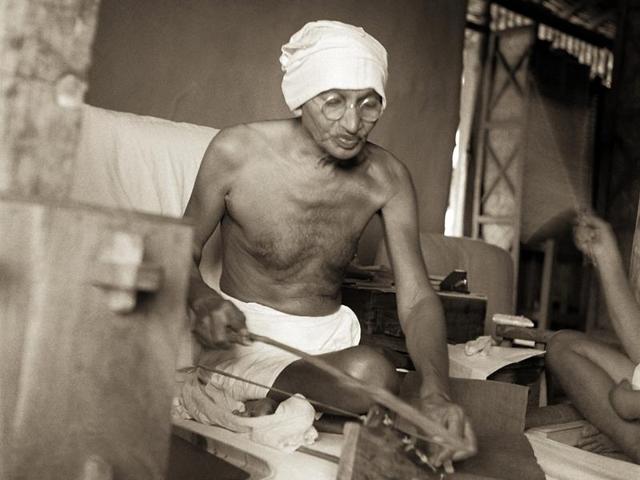 Mahatma Gandhi spinning on Dhanush Takli spinning instrument in his hut at Satyagraha Ashram, Sevagram, c August 1940. Mahatma Gandhi spinning on Dhanush Takli spinning instrument in his hut at Satyagraha Ashram, Sevagram, c August 1940.