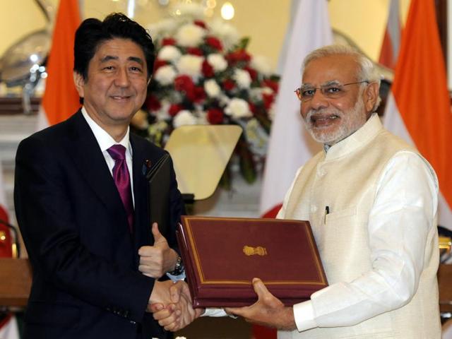 Japanese Prime Minister Shinzo Abe (L) shakes hands with his Indian counterpart Narendra Modi shake hands while exchanging documents after they signed an agreement between the two Asian nations at Hyderabad House in New Delhi on Saturday. (Sonu Mehta/HT Photo) Japanese Prime Minister Shinzo Abe (L) shakes hands with his Indian counterpart Narendra Modi shake hands while exchanging documents after they signed an agreement between the two Asian nations at Hyderabad House in New Delhi on Saturday. (Sonu Mehta/HT Photo)