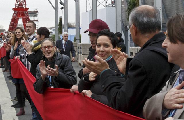 Climate activists applaud as they carry a red banner during a demonstration at the COP21, United Nations Climate Change Conference, in Le Bourget, north of Paris. (AP Photo) Climate activists applaud as they carry a red banner during a demonstration at the COP21, United Nations Climate Change Conference, in Le Bourget, north of Paris. (AP Photo)
