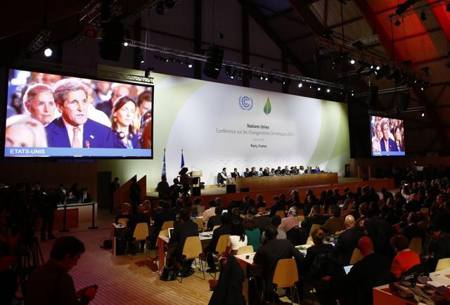 US Secretary of State John Kerry appears on television screens during the final conference at the COP21 in Le Bourget on Saturday. (AP) US Secretary of State John Kerry appears on television screens during the final conference at the COP21 in Le Bourget on Saturday. (AP)