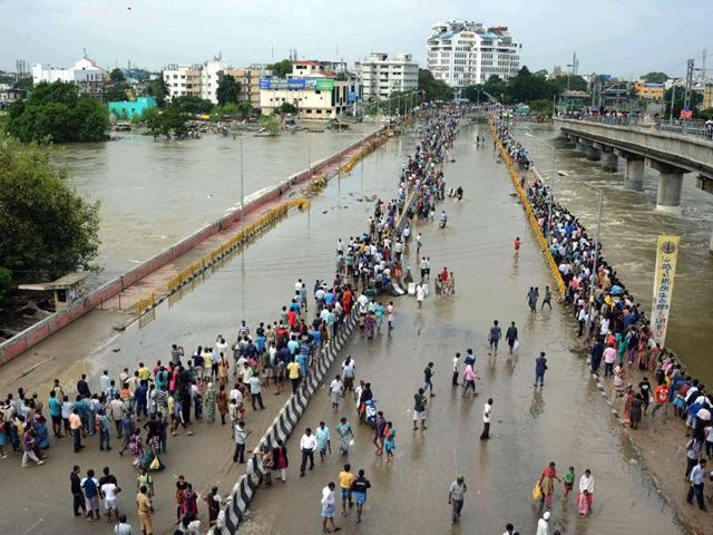 File photo of people travelling on a boat as they move to safer places through a flooded road in Chennai.(REUTERS)