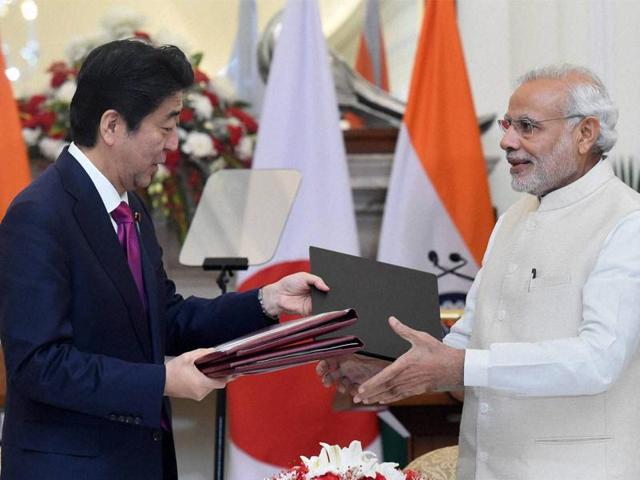 Prime Minister Narendra Modi (R) shakes hands with Japan’s Prime Minister Shinzo Abe at Hyderabad House in New Delhi on December 12, 2015.(HT Photo/Sonu Mehta)