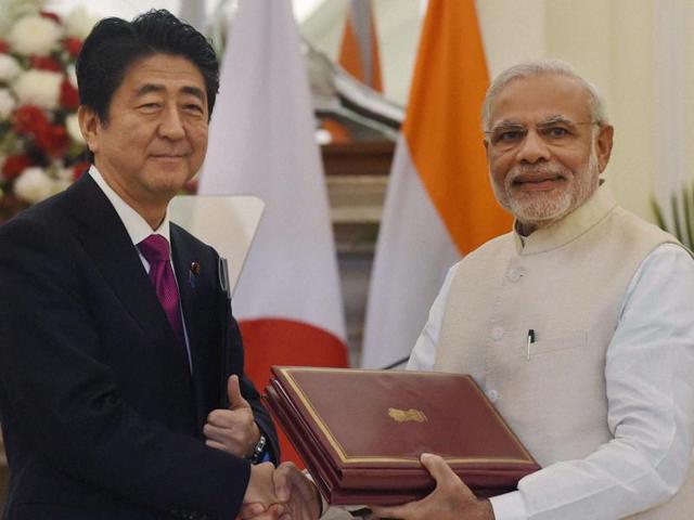 Prime Minister Narendra Modi and his Japanese counterpart Shinzo Abe exchange documents after signing an agreement at Hyderabad House in New Delhi on Saturday(PTI)