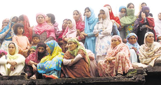 Kashmiri women watch a protest rally in Srinagar. A key demand of protesting citizens in the state has been the repeal of the Armed Forces Special Powers Act (AFSPA).. (HT PHOTO/WASEEM ANDRABI)