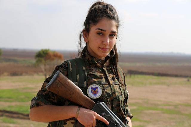 Syriac Christian Ormia, a member of the battalion "Female Protection Forces of the Land Between the Two Rivers" fighting the Islamic State group in Syria, poses during their training at their camp. (AFP Photo)