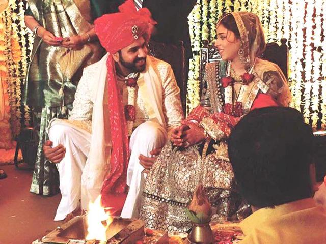 Running between the wickets: Rohit sneaks a moment to talk to his bride Ritika during the rituals. (Twitter)