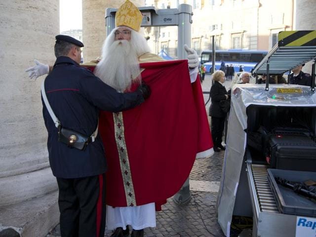 Germany’s Wolfgang Kimmig-Liebe, who has been volunteering as Santa Claus for years, is searched by a Carabiniere paramilitary police officer before entering in St. Peter’s Square at the Vatican to attend Pope Francis general audience, Wednesday, December 2, 2015. (AP)