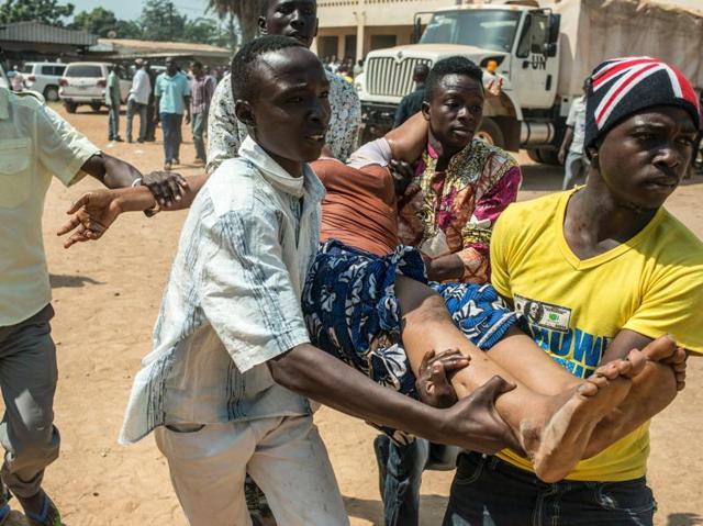 A group of men carry a woman who passed out as heavy gunfire is directed towards the Baya Dombia school, where voters were gathered for the Constitutional Referendum in Bangui. (AFP Photo) A group of men carry a woman who passed out as heavy gunfire is directed towards the Baya Dombia school, where voters were gathered for the Constitutional Referendum in Bangui. (AFP Photo)