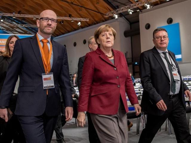 German Chancellor and Christian Democratic Union (CDU) leader Angela Merkel inspects the location for the CDU's party congress in Karlsruhe, southwestern Germany, on December 13, 2015. (AFP)