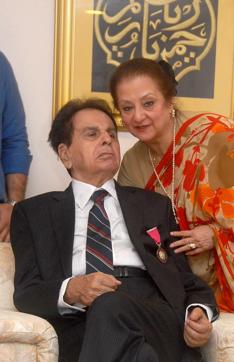 Bollywood actor Dilip Kumar wears the Padma Vibhushan award as he poses with his wife, actress Saira Banu. (AFP) Bollywood actor Dilip Kumar wears the Padma Vibhushan award as he poses with his wife, actress Saira Banu. (AFP)