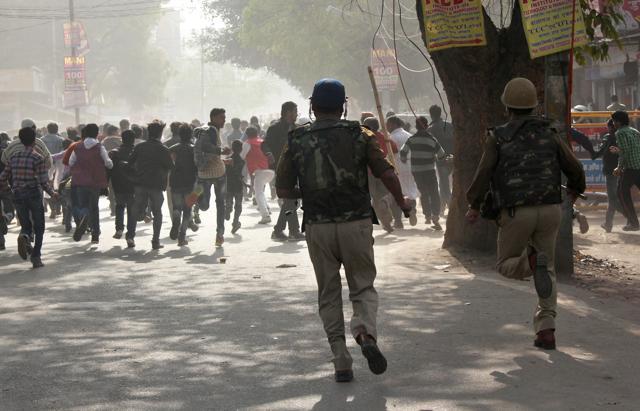 Cops chasing protesters during lathicharge in Lucknow’s Thakurganj area on Sunday. (Handout Photo)