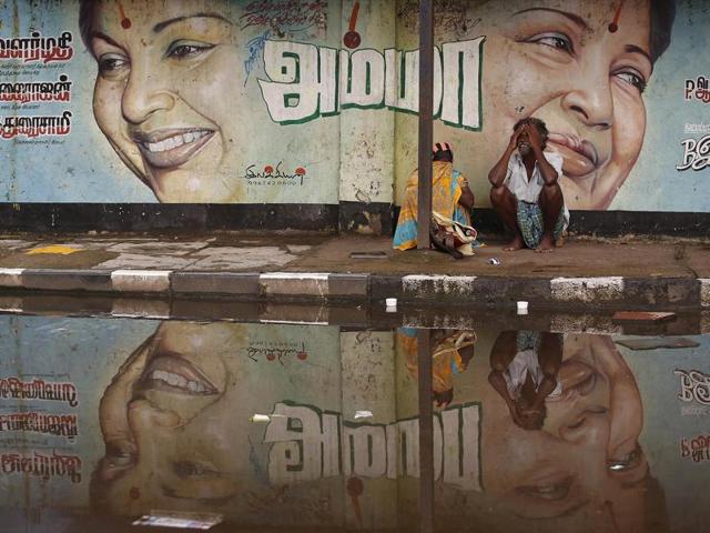 A flood-affected couple sits along a flooded roadside under a picture of Jayalalithaa, chief minister of the Tamil Nadu, in Chennai. (REUTERS) A flood-affected couple sits along a flooded roadside under a picture of Jayalalithaa, chief minister of the Tamil Nadu, in Chennai. (REUTERS)