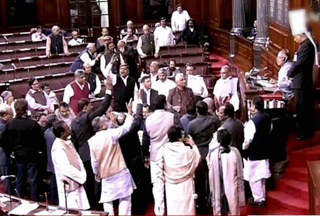 Opposition members protest in the well of the Rajya Sabha in New Delhi on Monday. (PTI) Opposition members protest in the well of the Rajya Sabha in New Delhi on Monday. (PTI)