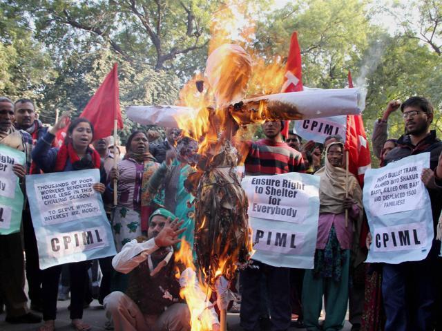 People burning an effigy of Railway Minister Suresh Prabhu during a protest over the demolition of a Shakur Basti slum, at Jantar Mantar in New Delhi on Tuesday (PTI) People burning an effigy of Railway Minister Suresh Prabhu during a protest over the demolition of a Shakur Basti slum, at Jantar Mantar in New Delhi on Tuesday (PTI)