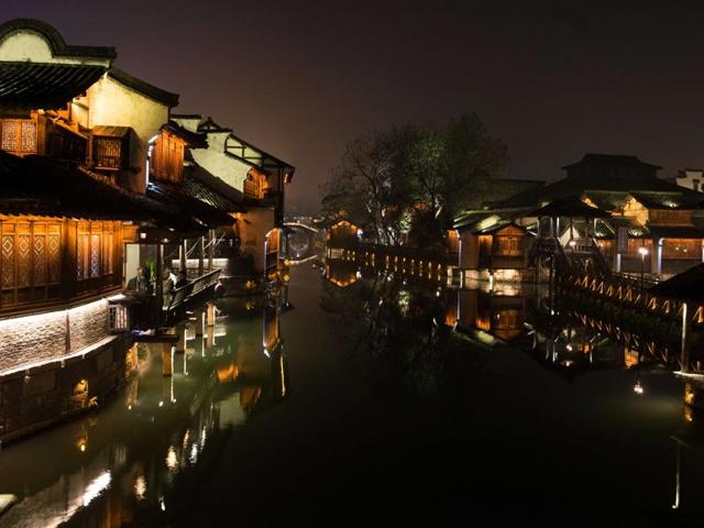 Participants (L) of the World Internet Conference sit and enjoy in a restaurant in the scenic town of Wuzhen in China's Zhejiang province, December 15, 2015. Wuzhen is at the centre of the six ancient towns south of river Yangtze, part of Tongxiang city in northern China. (AFP) Participants (L) of the World Internet Conference sit and enjoy in a restaurant in the scenic town of Wuzhen in China's Zhejiang province, December 15, 2015. Wuzhen is at the centre of the six ancient towns south of river Yangtze, part of Tongxiang city in northern China. (AFP)