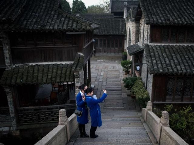 Volunteers take a selfie at dawn in Wuzhen, China where the World Internet Conference takes place, on December 16, 2015. (AFP) Volunteers take a selfie at dawn in Wuzhen, China where the World Internet Conference takes place, on December 16, 2015. (AFP)