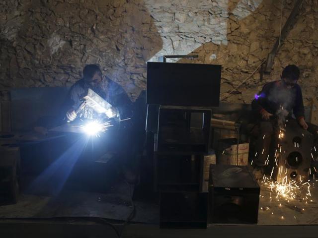 Men work in a factory that manufactures fireplace heaters in the southern countryside of Idlib, Syria. (REUTERS) Men work in a factory that manufactures fireplace heaters in the southern countryside of Idlib, Syria. (REUTERS)