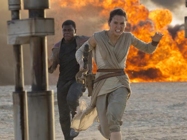 This photo provided by Disney/Lucasfilm shows Daisy Ridley, right, as Rey, and John Boyega as Finn, in a scene from the film, Star Wars: The Force Awakens, directed by JJ Abrams. Early screenings of the film began Thursday.(AP)