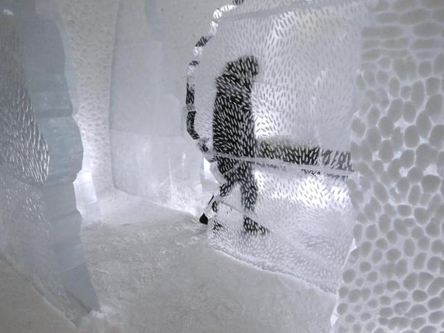 A man inside a room in the hotel. It is made from 4,000-5,000 tons of ice and boasts chandeliers made from 1,000 hand-cut ice-crystals.  (REUTERS) 