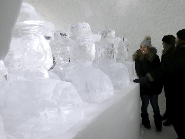 Guests looking at ice sculptures inside a room in the Ice hotel in Sweden. The project-cum-hotel, now 25 years old, is in Jukkasjärvi, a tiny little town 200 km north of the Arctic Circle. (REUTERS) 