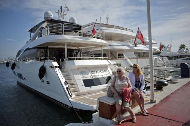 Two women sit near docked yatchs in Puerto Banus near Marbella. Many Spaniards who just a few years ago had easy access to trips abroad, tickets to football matches and cars are now struggling to make ends meet. (AFP) Two women sit near docked yatchs in Puerto Banus near Marbella. Many Spaniards who just a few years ago had easy access to trips abroad, tickets to football matches and cars are now struggling to make ends meet. (AFP)