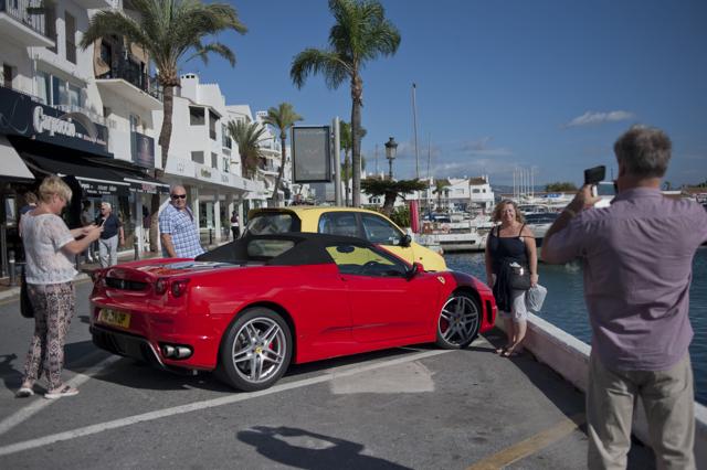 People take pictures of a Ferrari in Puerto Banus near Marbella. The success of brands like Lamborghini and Ferrari in Spain is a sign of how the rich have become richer during the country’s economic downturn while the ranks of the poor have swelled, a hot-button issue in Sunday’s general election. (AFP) People take pictures of a Ferrari in Puerto Banus near Marbella. The success of brands like Lamborghini and Ferrari in Spain is a sign of how the rich have become richer during the country’s economic downturn while the ranks of the poor have swelled, a hot-button issue in Sunday’s general election. (AFP)
