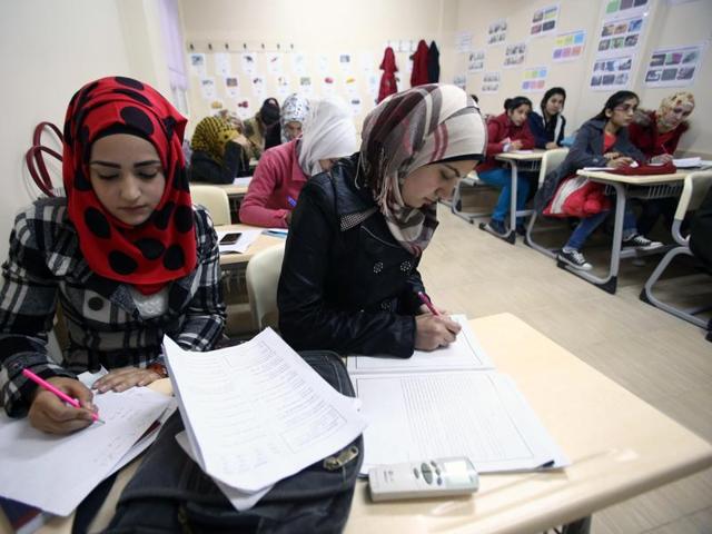 Syrian refugee teenagers attend a class at a school in Turkey near the Syrian border. Turkey is home to at least 2.2 million Syrian refugees after President Recep Tayyip Erdogan declared an open door policy at the onset of the Syrian crisis.(AFP)