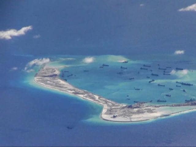 Chinese dredging vessels are purportedly seen in the waters around Mischief Reef in the disputed Spratly Islands in the South China Sea in this still image from video taken by a P-8A Poseidon surveillance aircraft provided by the United States Navy.(Reuters File Photo) Chinese dredging vessels are purportedly seen in the waters around Mischief Reef in the disputed Spratly Islands in the South China Sea in this still image from video taken by a P-8A Poseidon surveillance aircraft provided by the United States Navy.(Reuters File Photo)